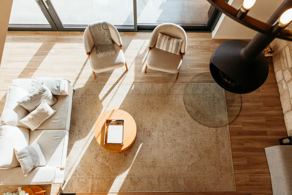 A cozy living room with a neutral-toned durable rug, wooden flooring, and modern furniture, emphasizing rugs that last the longest.