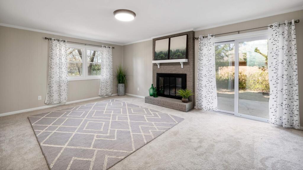 Spacious living room with a modern geometric patterned carpet in grey tones, created by a leading custom-designed carpets manufacturer, adding elegance to the decor