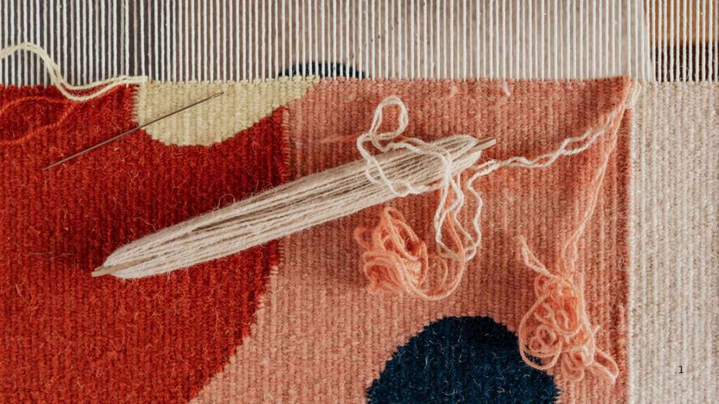 "An artisan weaving a colorful wool rug on a loom, illustrating the intricate craftsmanship and vibrant designs possible with high-quality New Zealand wool."