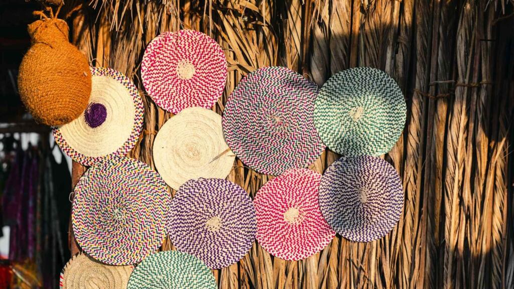 Round rugs in various colors and patterns displayed on a clean, light-colored floor, showcasing their circular shape and texture
