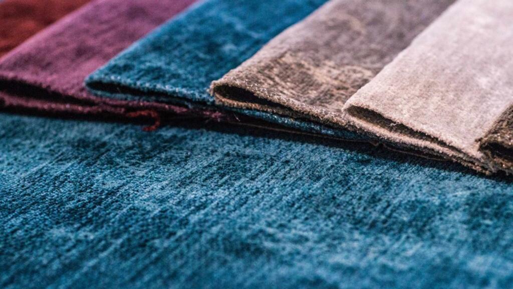 Close-up of a modern rug made from innovative, sustainable materials showcasing unique textures and colors.