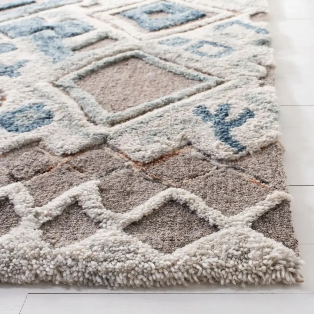 A soft, high-pile rug with a subtle diamond and cactus motif in shades of gray, beige, and blue, displayed on a light-colored wooden floor.